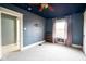 Spacious bedroom with gray walls, a ceiling fan, and plenty of natural light for a comfortable space at 616 N Bancroft St, Indianapolis, IN 46201