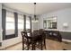 Elegant dining room featuring a dark wood dining table and a built-in bench under three bright windows at 616 N Bancroft St, Indianapolis, IN 46201