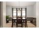 Formal dining room with a dark wood table, elegant chandelier, neutral carpet and decorative gray walls at 616 N Bancroft St, Indianapolis, IN 46201