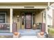 Charming front porch with detailed woodwork, a unique entrance and a 'Welcome To Our Porch' sign at 616 N Bancroft St, Indianapolis, IN 46201