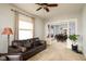 Spacious living room with a leather sofa, a floor lamp and an open view into the dining room at 616 N Bancroft St, Indianapolis, IN 46201