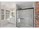 Modern bathroom featuring a glass shower, double sink vanity, and tile flooring at 625 N Parker Ave, Indianapolis, IN 46201