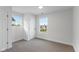 Bright bedroom features plush carpet, two windows, and neutral paint at 625 N Parker Ave, Indianapolis, IN 46201