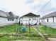 Fenced backyard featuring a swing set and small patio area perfect for relaxing and outdoor fun at 640 W South St, Shelbyville, IN 46176