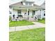 Charming home with a covered front porch, decorative railings, and well-maintained lawn at 640 W South St, Shelbyville, IN 46176