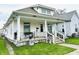 Traditional home featuring a covered porch with decorative railings and a well-manicured lawn at 640 W South St, Shelbyville, IN 46176