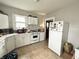 Efficient kitchen layout with white cabinets and appliances, ready for personal touches at 640 W South St, Shelbyville, IN 46176