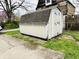 Outdoor storage shed with double doors and weathered gray roof, ideal for storing tools and equipment at 640 W South St, Shelbyville, IN 46176
