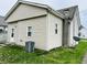 Side view of a house featuring vinyl siding, a chimney, and a well-kept lawn at 648 W South St, Shelbyville, IN 46176