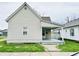 Charming home with neutral siding, inviting front porch and well-maintained lawn at 648 W South St, Shelbyville, IN 46176