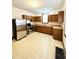 Functional kitchen with wood cabinetry, stainless steel appliances and vinyl flooring at 648 W South St, Shelbyville, IN 46176