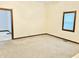 Cozy living room with neutral carpeting, trim, and a bright window at 648 W South St, Shelbyville, IN 46176
