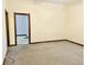 Spacious living room with plush neutral carpeting and a view into the hallway at 648 W South St, Shelbyville, IN 46176