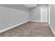 Unfinished basement area with carpeting and ample space for storage or customization to suit owner needs at 682 Keswick Dr, Brownsburg, IN 46112