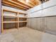 Unfinished basement with exposed ceiling beams and bare concrete foundation walls awaiting your personalized design at 682 Keswick Dr, Brownsburg, IN 46112