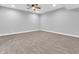 Spacious basement with neutral carpeting, ceiling fan, and ample natural light from recessed lighting at 682 Keswick Dr, Brownsburg, IN 46112