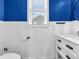 Modern bathroom with white vanity, black fixtures, and blue accent wall for a stylish look at 682 Keswick Dr, Brownsburg, IN 46112
