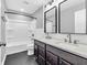 Bright bathroom featuring a double vanity, tub-shower, and modern fixtures with black hexagon tile flooring at 682 Keswick Dr, Brownsburg, IN 46112