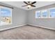 Bright bedroom with three windows, ceiling fan, and neutral carpeting at 682 Keswick Dr, Brownsburg, IN 46112