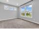 Bright bedroom with three windows offering natural light, with neutral carpet and paint at 682 Keswick Dr, Brownsburg, IN 46112