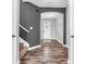 Warm entryway with hardwood floors, a staircase, and a view of the front door, offering a grand first impression at 682 Keswick Dr, Brownsburg, IN 46112