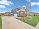 Beautiful two-story home featuring a manicured lawn, landscaping, and a private driveway leading to the garage at 682 Keswick Dr, Brownsburg, IN 46112