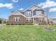 Charming two-story home with a brick facade, blue siding, manicured lawn, and inviting curb appeal at 682 Keswick Dr, Brownsburg, IN 46112