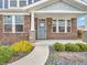 Inviting front entry with a blue door, brick facade, decorative stone accents, and meticulously landscaped garden at 682 Keswick Dr, Brownsburg, IN 46112