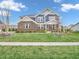 Charming two-story home with brick and siding exterior, manicured lawn, and delightful landscaping at 682 Keswick Dr, Brownsburg, IN 46112