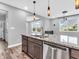 Bright kitchen with granite countertops, modern fixtures, and stainless steel dishwasher at 682 Keswick Dr, Brownsburg, IN 46112