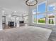 Open-concept living room with high ceilings, large windows, and a view of the kitchen at 682 Keswick Dr, Brownsburg, IN 46112