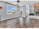 Bright living room features large windows, fireplace, wood floors, and a modern light fixture at 682 Keswick Dr, Brownsburg, IN 46112