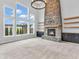 Inviting living room with stone fireplace, custom built-ins, and expansive windows at 682 Keswick Dr, Brownsburg, IN 46112