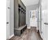 Mudroom with custom built-in storage, bench, and hardwood floors perfect for storage and organization at 682 Keswick Dr, Brownsburg, IN 46112