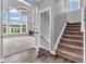 Inviting staircase, hardwood floors, and lots of light create a grand entrance with seamless access to the upper levels at 682 Keswick Dr, Brownsburg, IN 46112