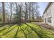 View of large backyard with patio seating and wood privacy fence at 6853 Bretton Wood Dr, Indianapolis, IN 46268