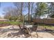 Backyard featuring patio set, wood fence surround, and shade trees at 6853 Bretton Wood Dr, Indianapolis, IN 46268
