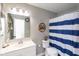 Bathroom featuring nautical-themed decor, a vanity, and a blue and white striped shower curtain at 6853 Bretton Wood Dr, Indianapolis, IN 46268