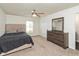 Relaxing bedroom includes a ceiling fan, comfy bed, dresser, and soft neutral carpet at 6853 Bretton Wood Dr, Indianapolis, IN 46268