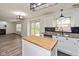 Bright kitchen with white cabinets, butcher block island, stainless steel appliances, and access to the backyard at 6853 Bretton Wood Dr, Indianapolis, IN 46268
