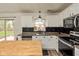 Updated kitchen showcasing stainless steel appliances, white cabinets and butcher block island at 6853 Bretton Wood Dr, Indianapolis, IN 46268