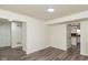 Bright, open-concept living room featuring modern flooring and an open doorway to the kitchen at 6853 Bretton Wood Dr, Indianapolis, IN 46268