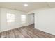 Spacious living room with updated flooring and natural light from two large windows at 6853 Bretton Wood Dr, Indianapolis, IN 46268