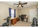 Bedroom featuring a ceiling fan, built-in workstation and exercise equipment at 6953 Beargrass Ct, Indianapolis, IN 46241