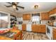 Bright kitchen with wood cabinets, modern appliances, and a cozy dining area at 6953 Beargrass Ct, Indianapolis, IN 46241