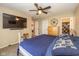 Comfortable main bedroom featuring carpeted floors, a ceiling fan, and an attached TV at 6953 Beargrass Ct, Indianapolis, IN 46241