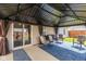 Covered patio includes seating, an outdoor rug, and a grill at 6953 Beargrass Ct, Indianapolis, IN 46241