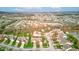 Expansive aerial view of a suburban neighborhood featuring well-maintained homes and a scenic pond at 7150 Brant Pointe Cir, Indianapolis, IN 46217