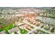 An aerial view shows beautiful homes encircling a serene lake, with commercial businesses in the distance at 7150 Brant Pointe Cir, Indianapolis, IN 46217