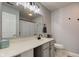 Neutral bathroom with a large mirror, modern vanity, and toilet at 7150 Brant Pointe Cir, Indianapolis, IN 46217